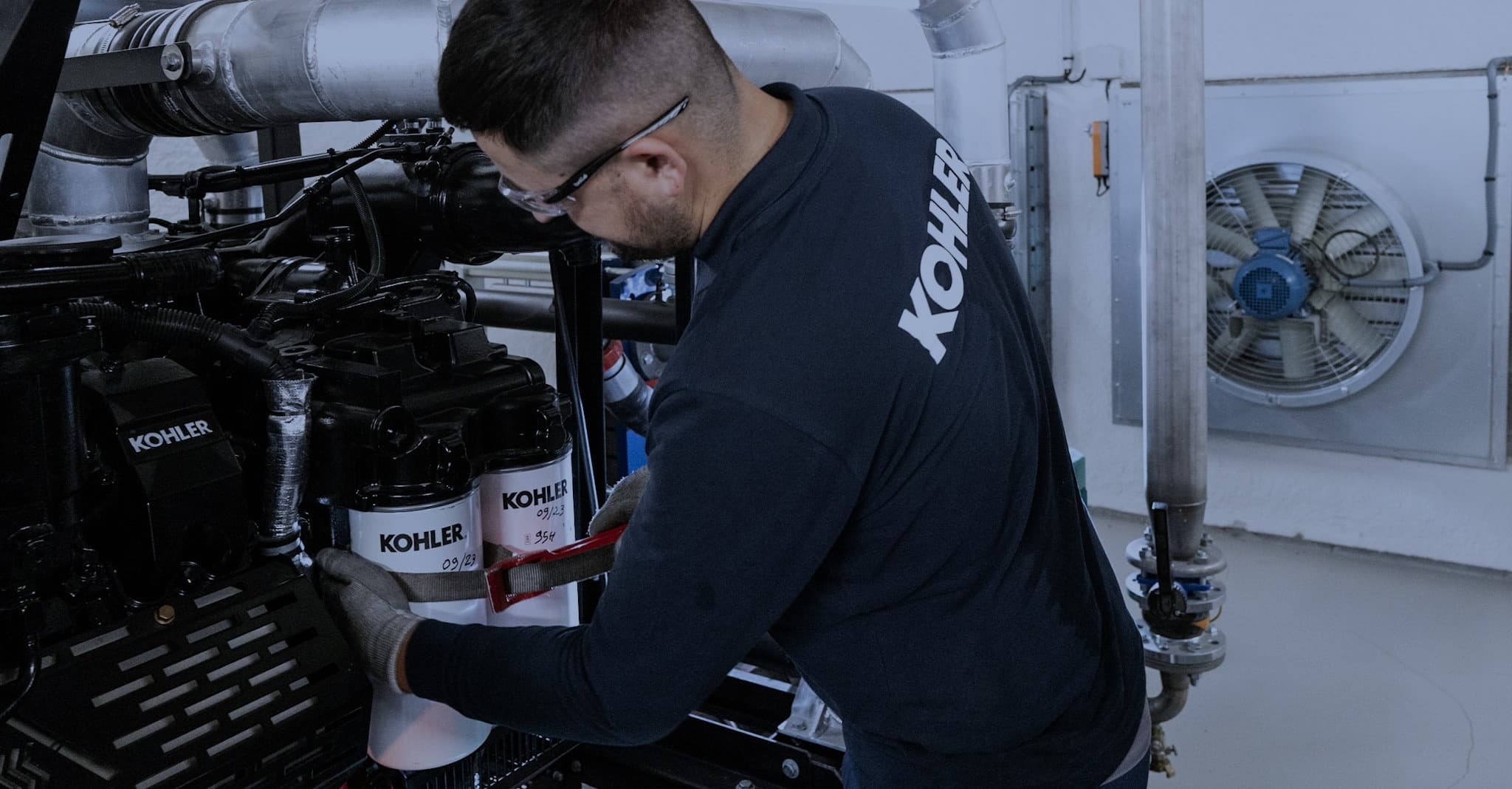 KOHLER Technician providing maintance on generator set