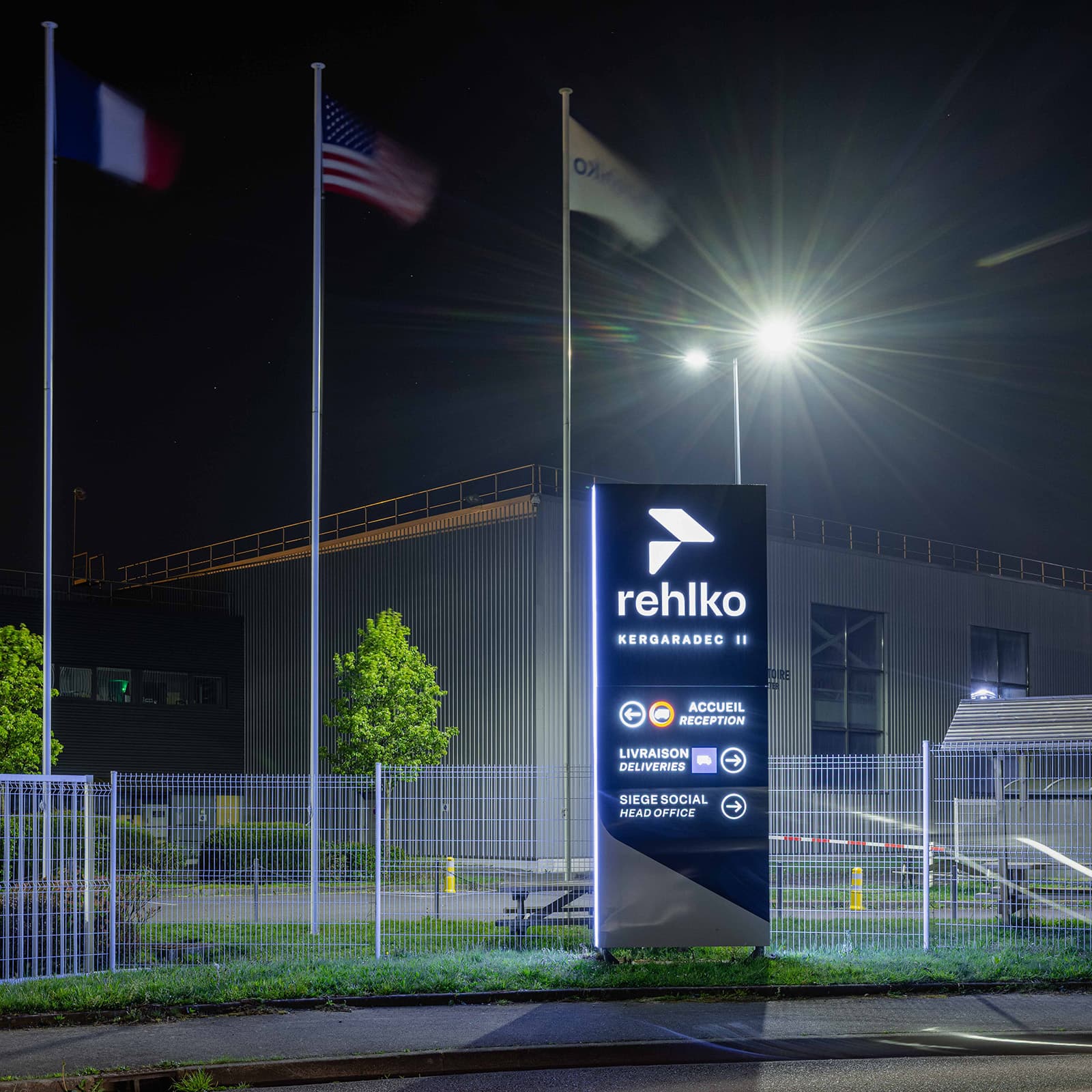 Rehlko Totem Ouside Building at Night